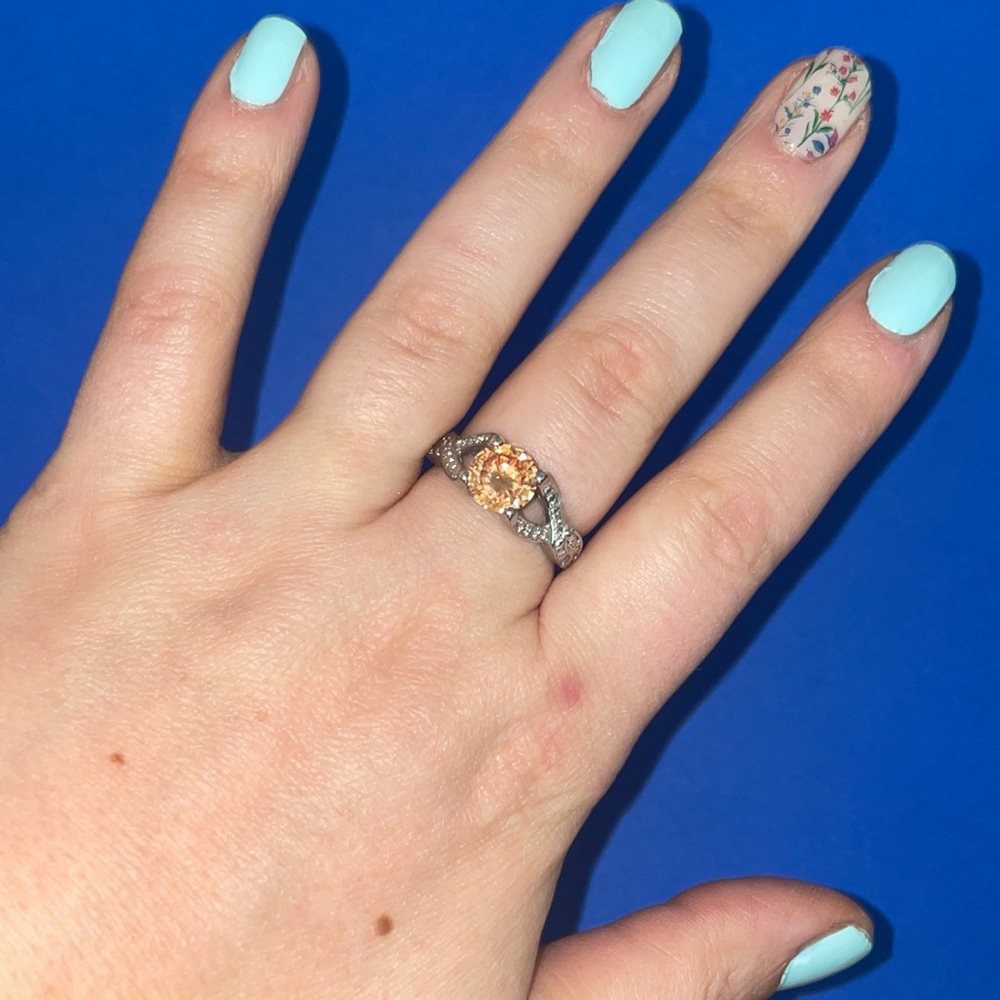Silver toned ring with amber clear stone